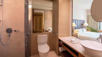 A modern bathroom with a toilet, bidet, and sink.