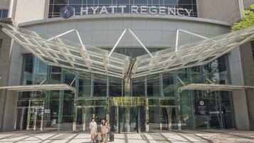 The Hyatt Regency hotel entrance with a modern glass facade and a distinctive geometric canopy structure.