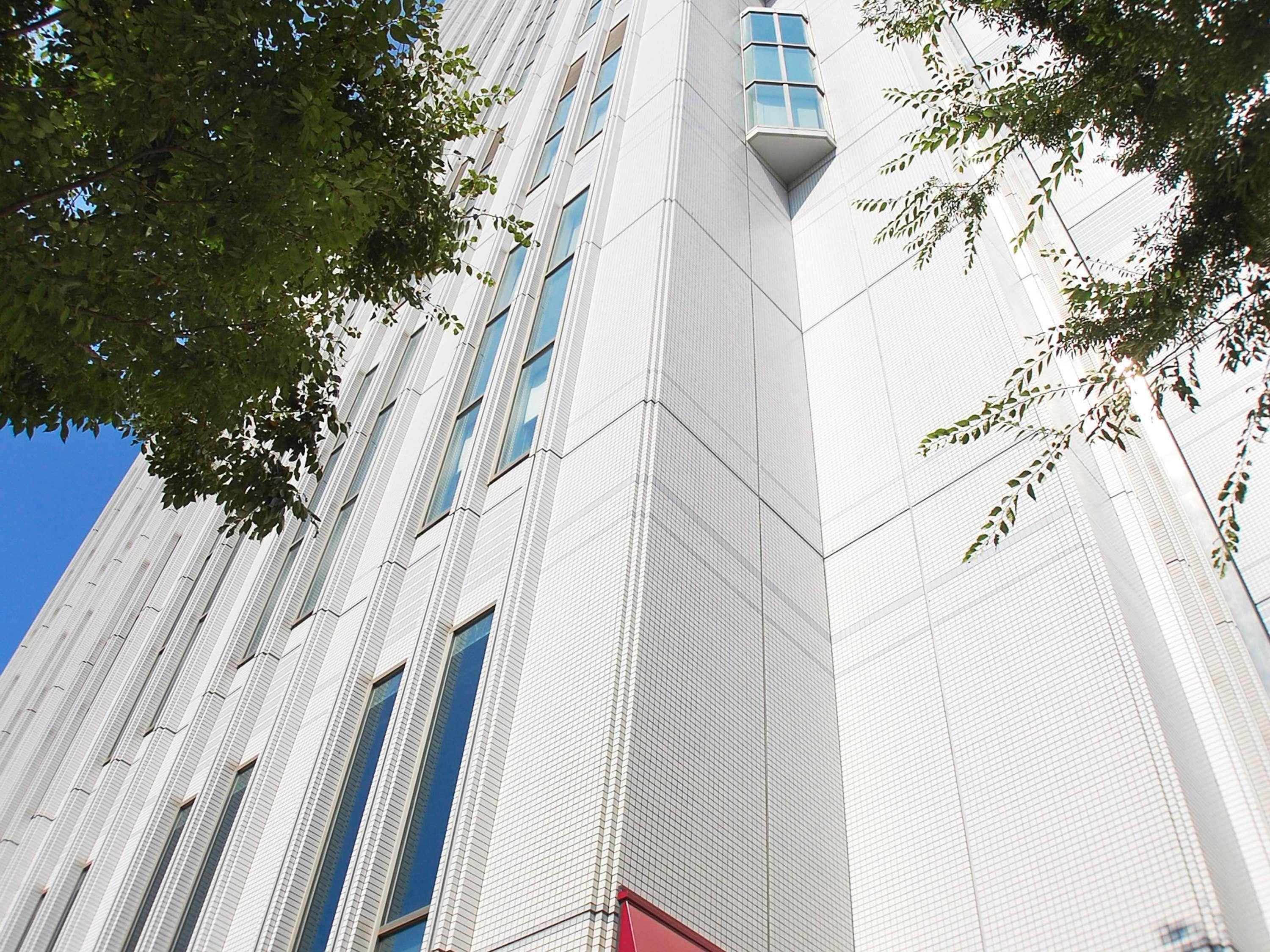 A modern building with a grid-like facade and multiple windows.