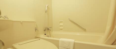 A bathroom with a toilet, a bathtub, and a shower.