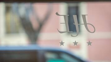 A window with a logo and three stars.