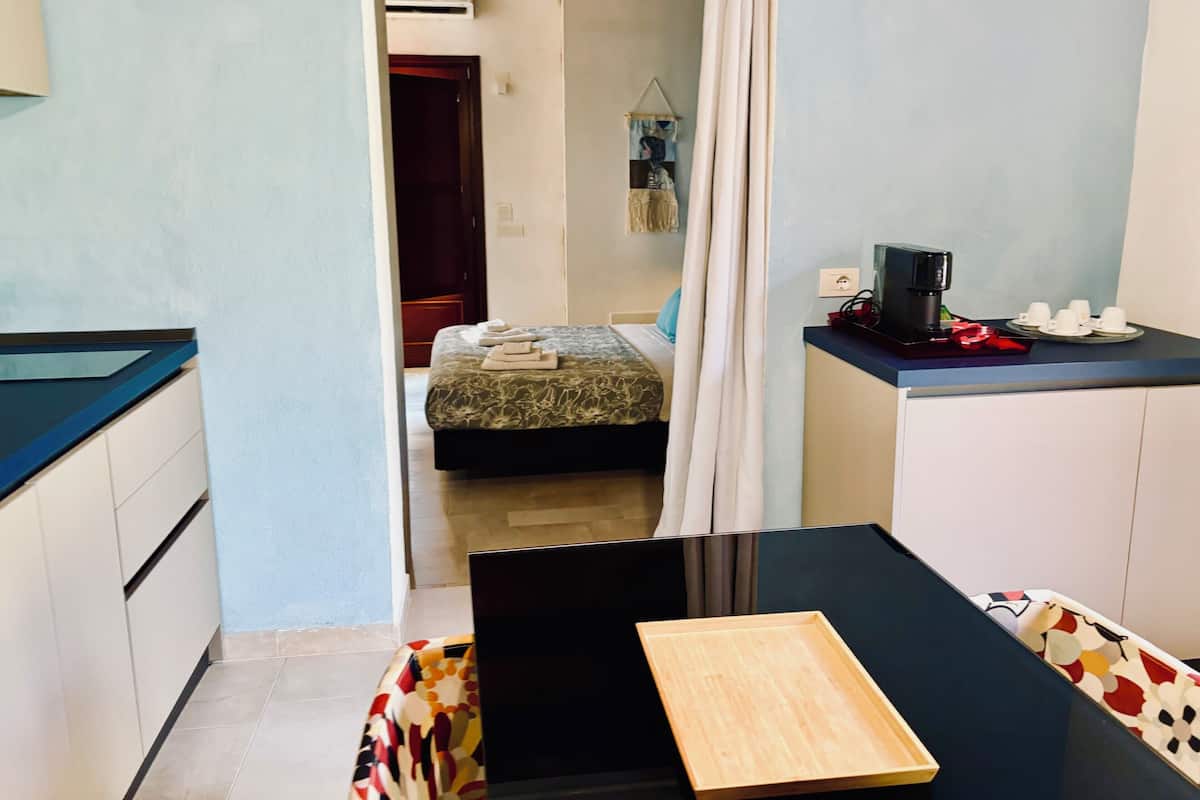 Comfort Condo, 1 Bedroom, Kitchen, Courtyard Area | 1 bedroom, blackout drapes, soundproofing, iron/ironing board