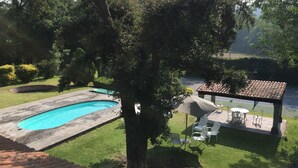 Una piscina, un gazebo e area relax all'aperto.