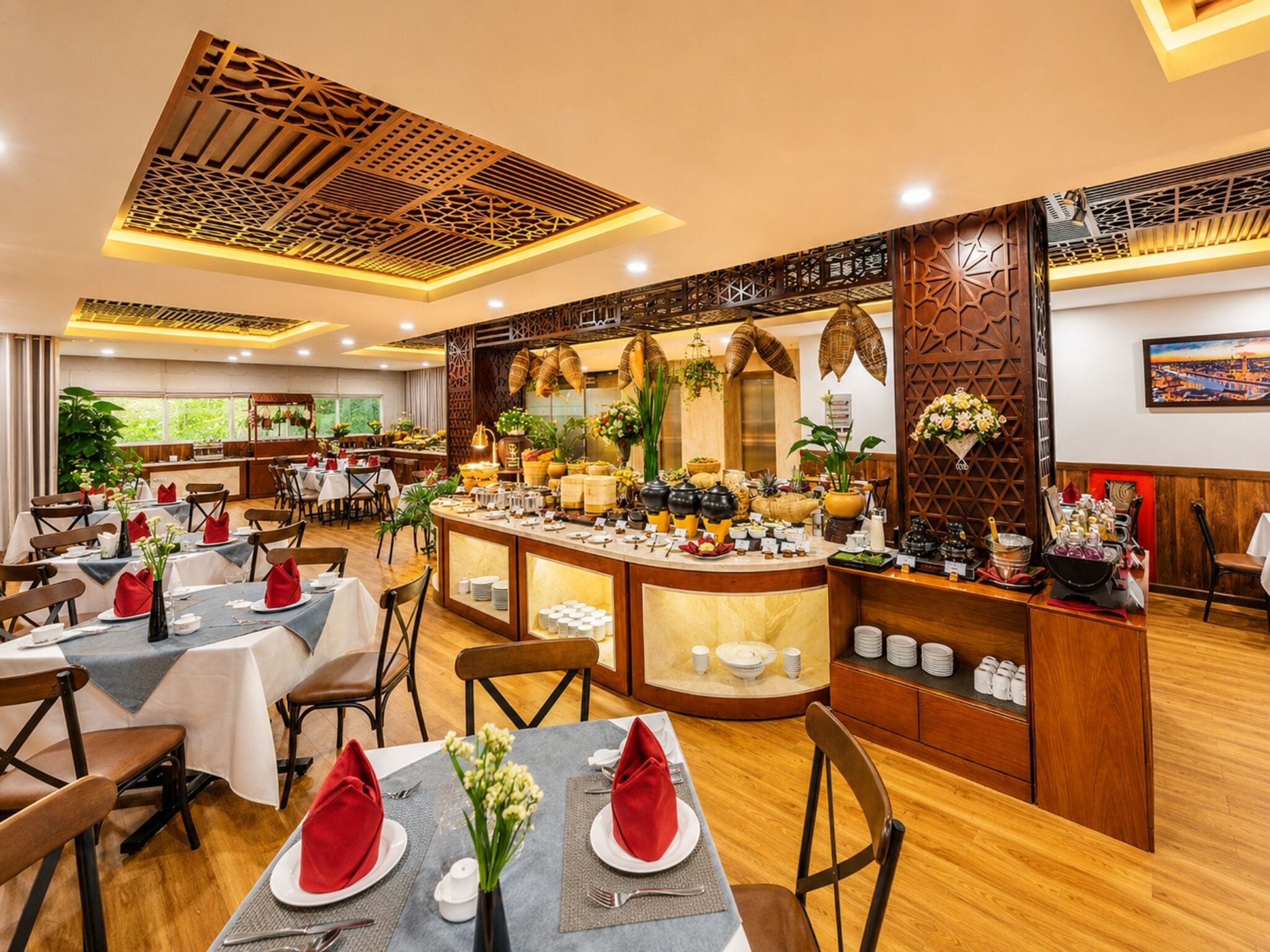 A restaurant with multiple tables, a buffet counter, and a decorative ceiling.