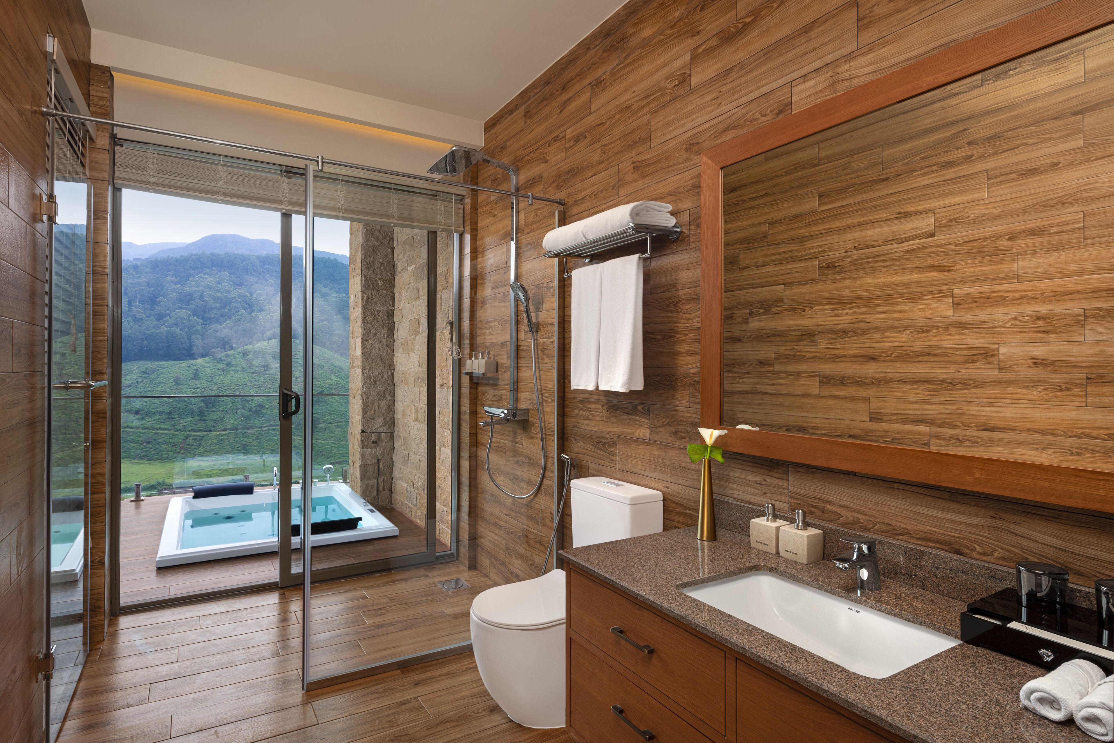 A modern bathroom with a glass shower, a bathtub, and a large mirror.