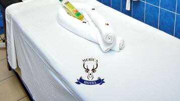 Relax in a stylish room with a large bed, bathtub, and amenities at your fingertips.