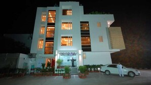 A modern building with multiple floors, large windows, and a central entrance with steps. - Nangi's Pride (Jaipur)