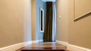 A staircase leading to a room with a window and a curtain. - Il Covo (Rome)