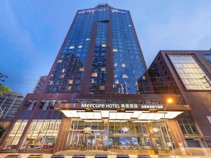 A tall hotel building with a prominent sign at the top. - Mercure Chengdu Chunxi Taikoo Li (Chengdu)