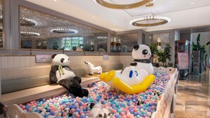 A reception area with a ball pit, plush toys, and a modern chandelier. - Mercure Chengdu Chunxi Taikoo Li (Chengdu)