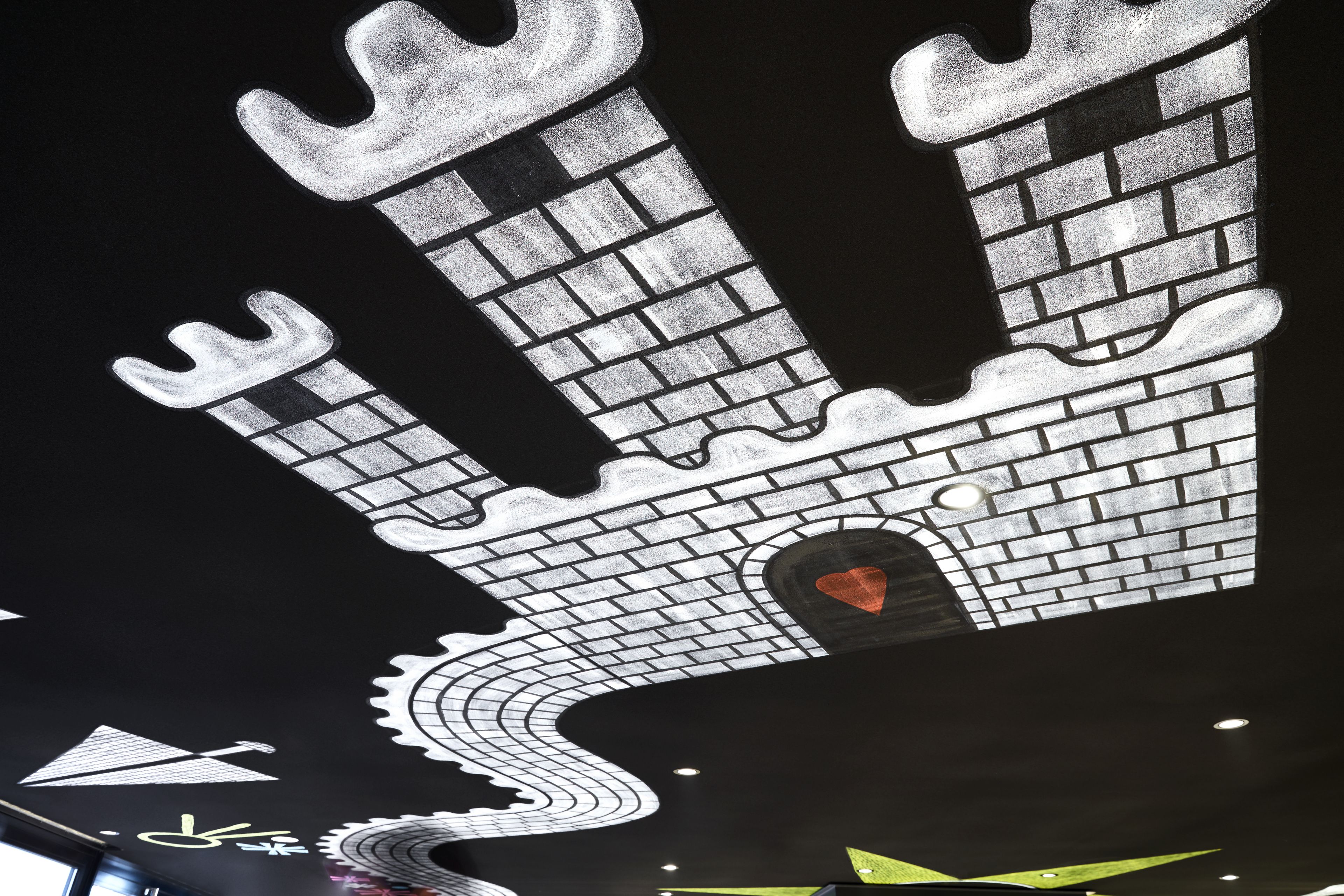 A large, illuminated architectural feature resembling a castle with a heart-shaped window.