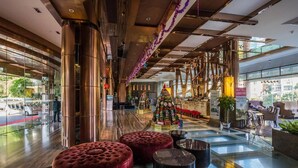 A spacious lobby with a large glass wall, a central Christmas tree, and modern seating areas. - Guangzhou Yihe Hotel (Guangzhou)
