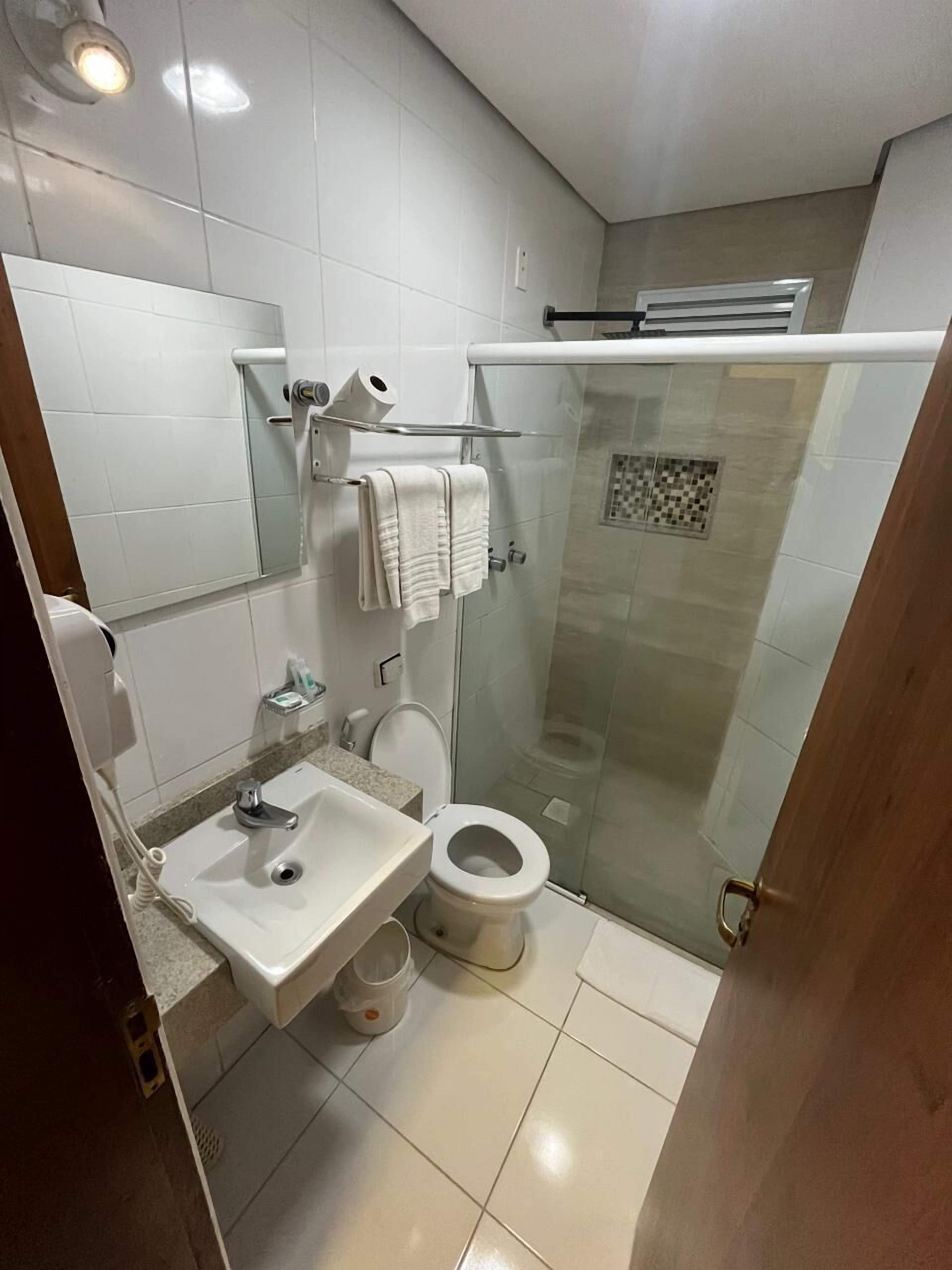 superior single room | bathroom | shower, hair dryer, towels, soap
