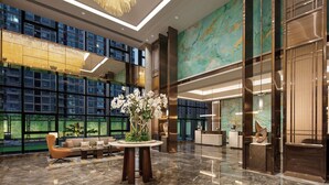 A modern lobby with a reception desk, seating area, and large windows. - Doubletree by Hilton Yangzhou (Yangzhou)