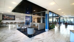 A modern lobby with a seating area, a large wall mural, and a sign reading 'BERRY FARMS'. - Holiday Inn Express & Suites Franklin - Berry Farms by IHG (Franklin)