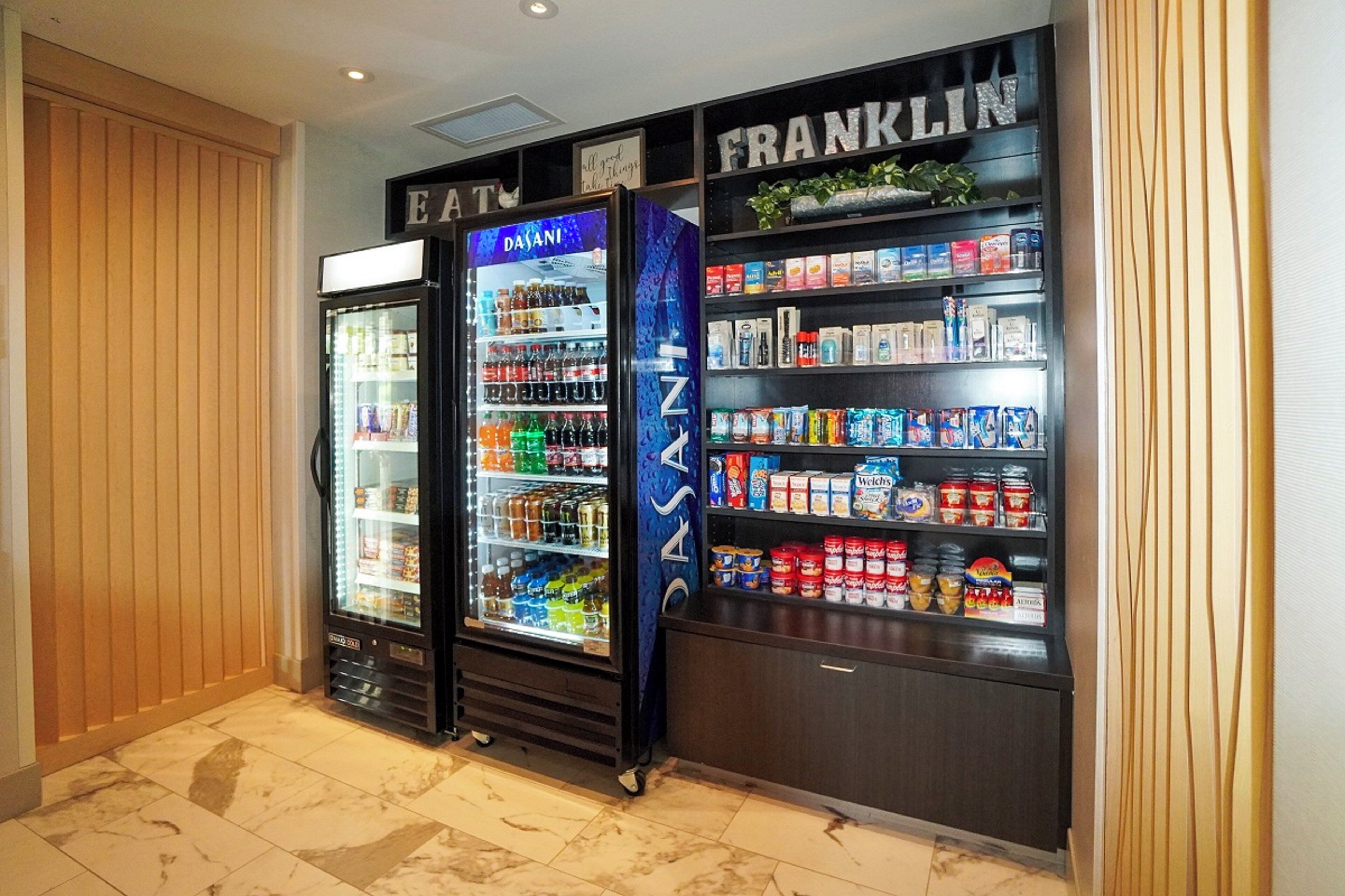 Un área de venta con dos dispensadores de bebidas y un estante para aperitivos.