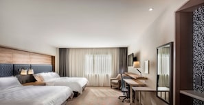 A hotel room with two beds, a desk, a chair, a TV, and a large window with curtains. - Holiday Inn & Suites Aguascalientes by IHG (Aguascalientes)