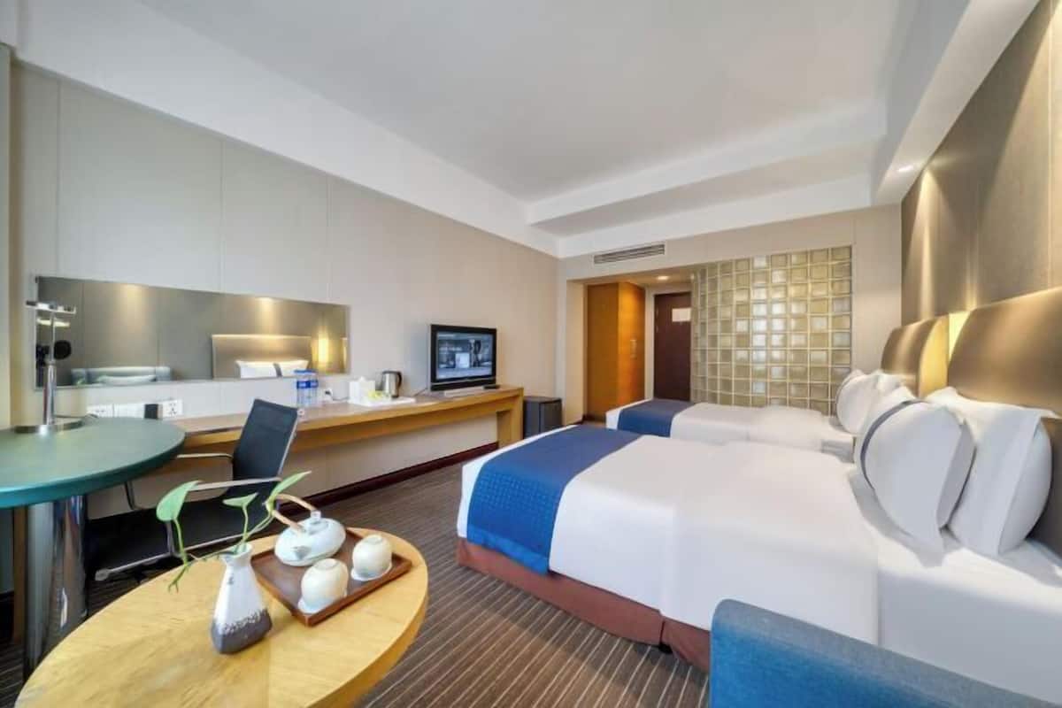 Premium bedding, desk, laptop workspace, soundproofing