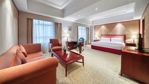 A hotel room with a bed, a sofa, a desk, and a chair. - Hangzhou Haiwaihai Communication Hotel (Hangzhou)