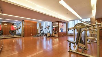 A gym with treadmills, elliptical machines, and weight equipment.