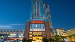 A tall hotel building with a prominent sign for the Haiwaihai Hotel. - Hangzhou Haiwaihai Hotel (Hangzhou)