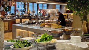 A buffet setup with various food items and utensils. - Hangzhou Haiwaihai Hotel (Hangzhou)