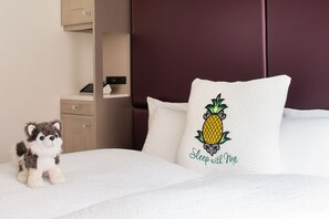 A bed with a white pillow featuring a pineapple design and the text "Sleep with Me." - Staypineapple, An Artful Hotel, Midtown (New York)