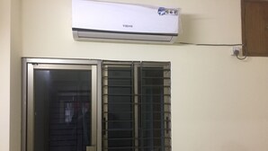 A room with a window, a door, and an air conditioning unit mounted on the wall. - Latif villa (Dhaka)