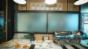 A breakfast buffet with various food items and a coffee station. - Louisland Hotel (Hanoi)