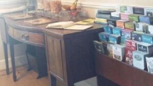 A room with a wooden desk, a bookshelf with books, and a framed painting on the wall. - Winton House (Stratford-upon-Avon)