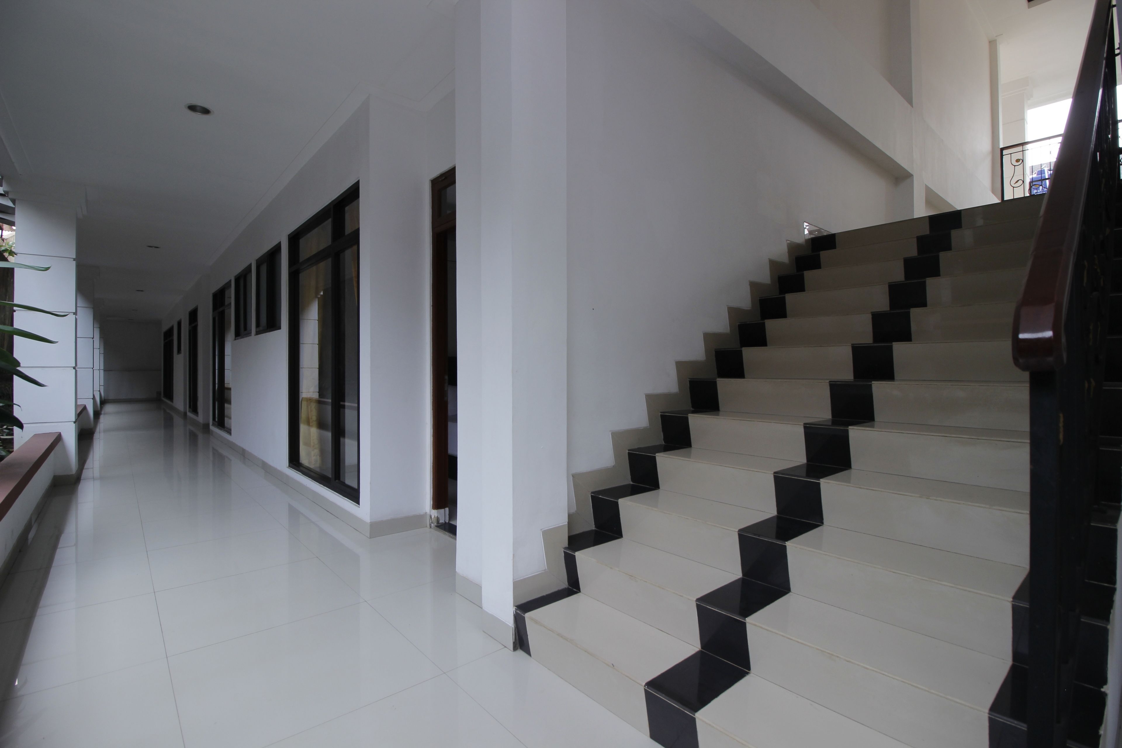 A modern interior with a staircase leading to an upper floor.