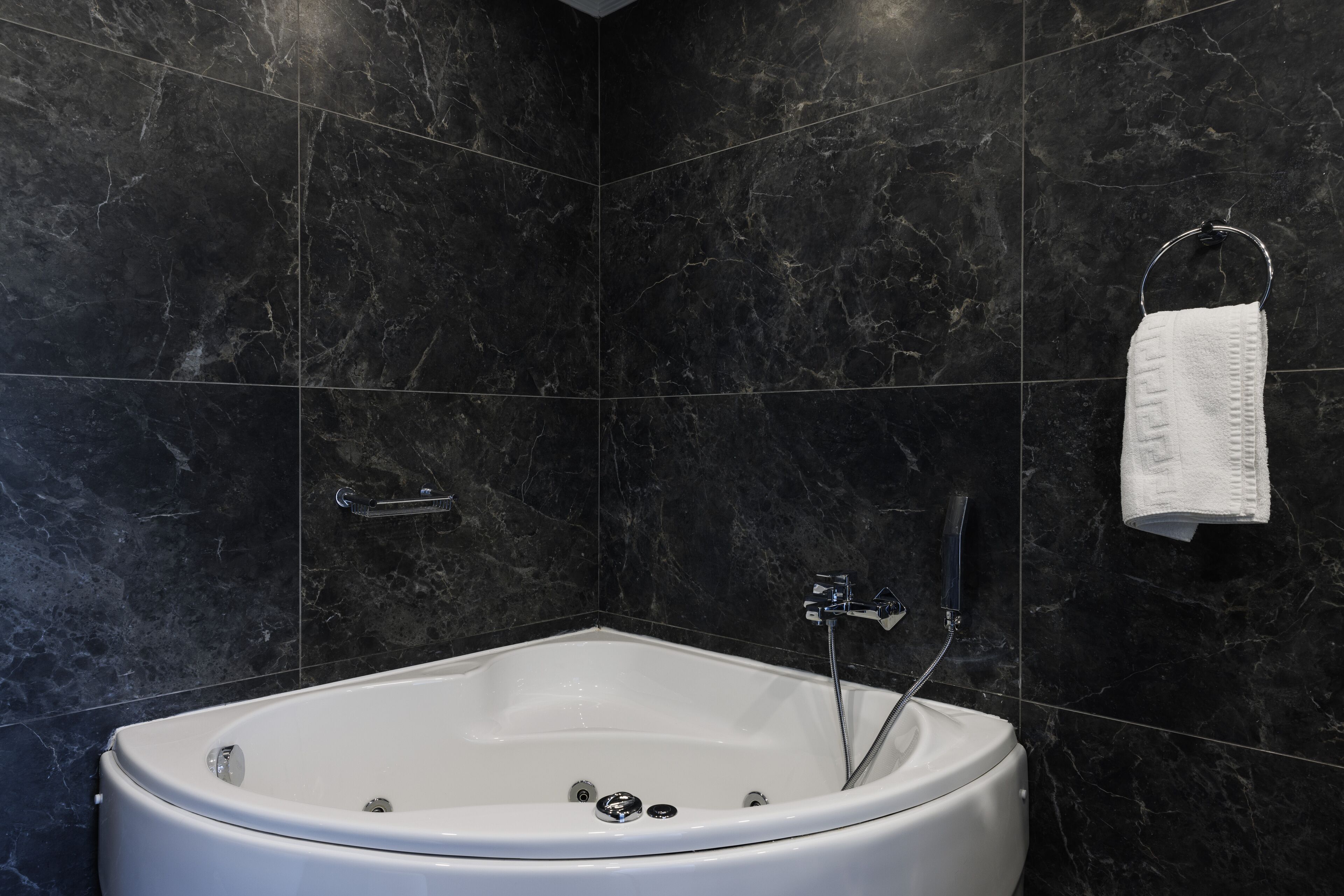 acropolis corner suite with balcony and jetted tub | bathroom | free toiletries, hair dryer, slippers, towels