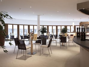 A modern conference room with a long table, chairs, and a bar area. - Aqua Dome Therme (Laengenfeld)