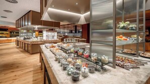 A buffet area with various food items and containers. - Aqua Dome Therme (Laengenfeld)