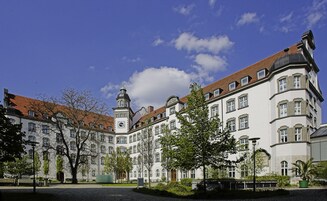 A historic building with multiple windows and a clock tower.