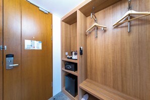 A wooden locker room with a digital scale, a coffee machine, and a small black refrigerator. - Holiday Inn Express Jakarta Menteng by IHG (Jakarta)