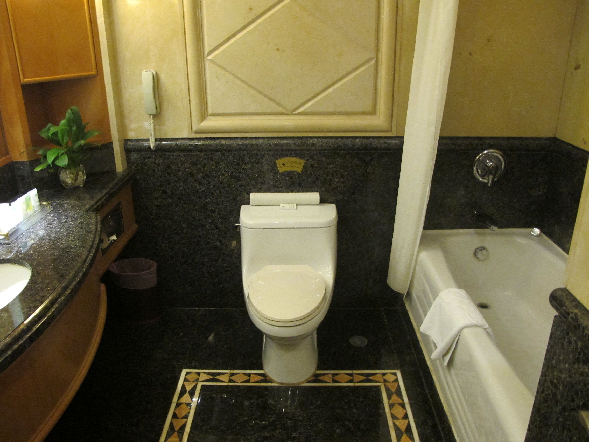 A bathroom with a toilet, sink, and bathtub.