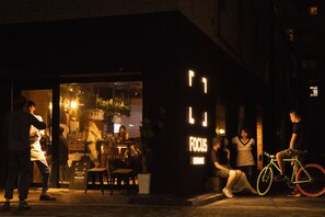 Escena urbana nocturna con una tienda llamada 'FOCUS'.