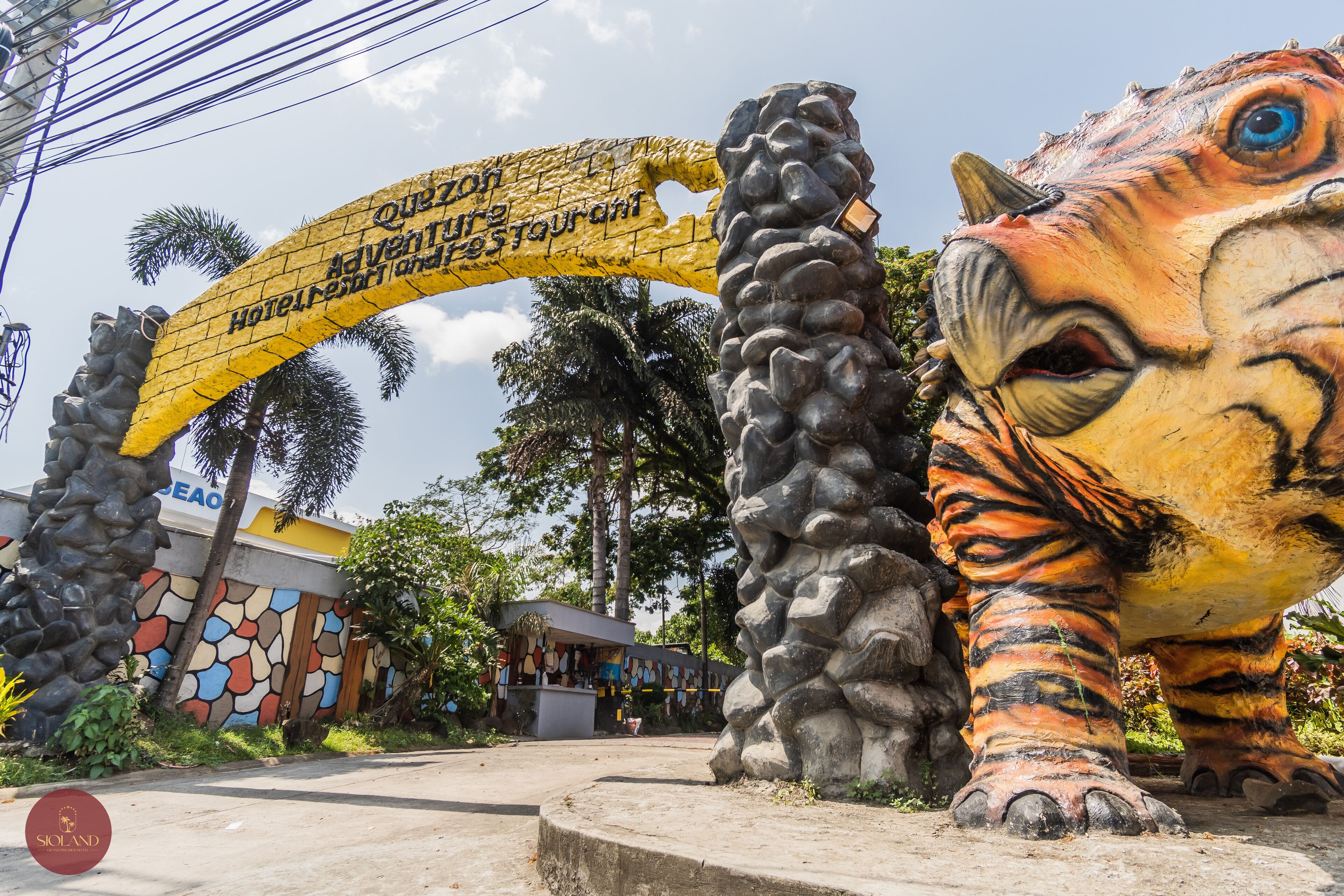 A large tiger statue with a yellow archway in the background.