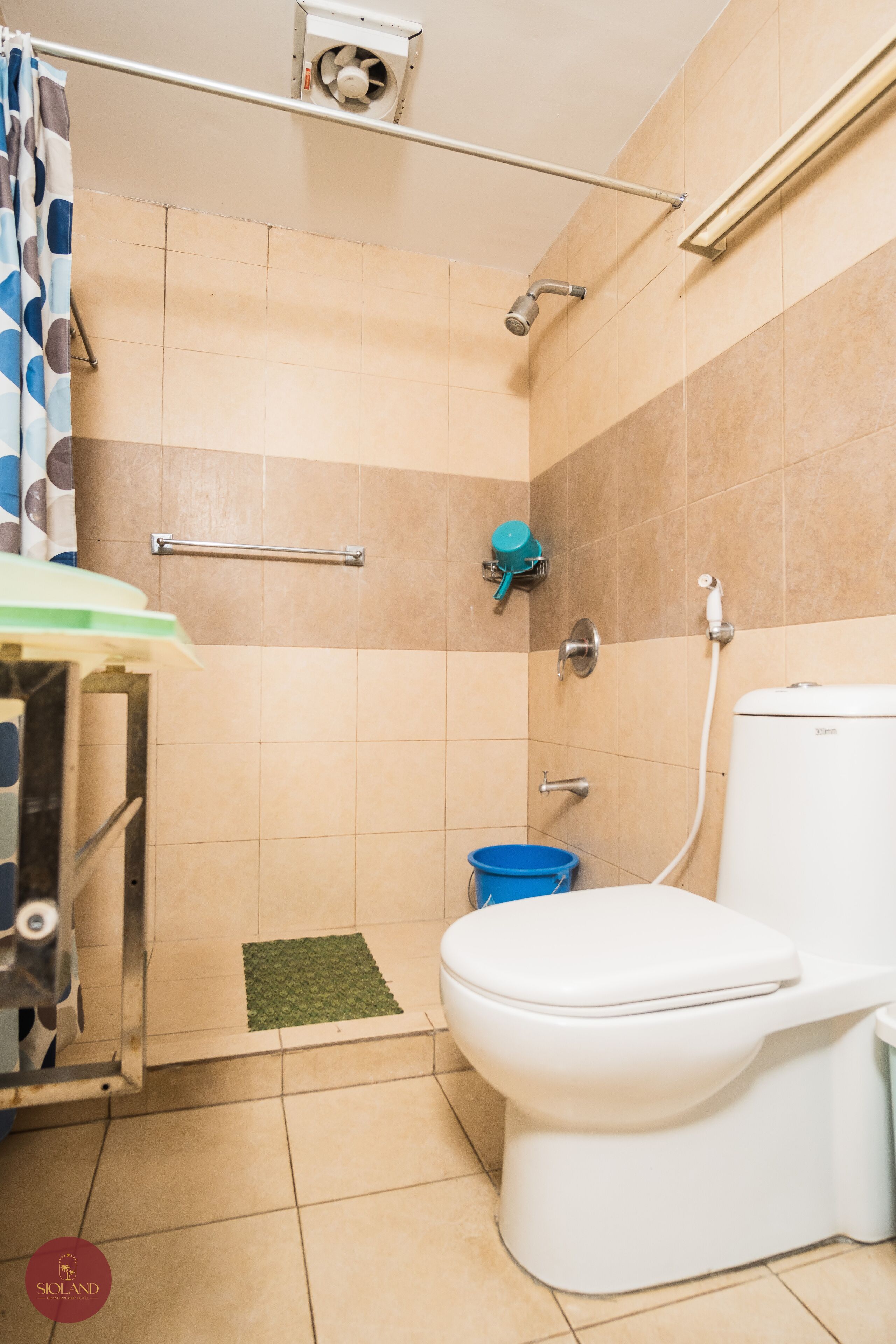 A bathroom with a shower, toilet, and sink.