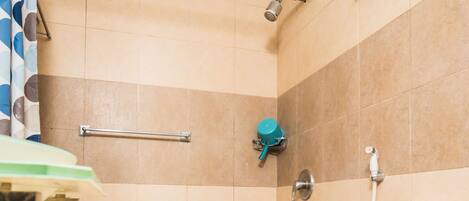 A bathroom with a shower, toilet, and sink.