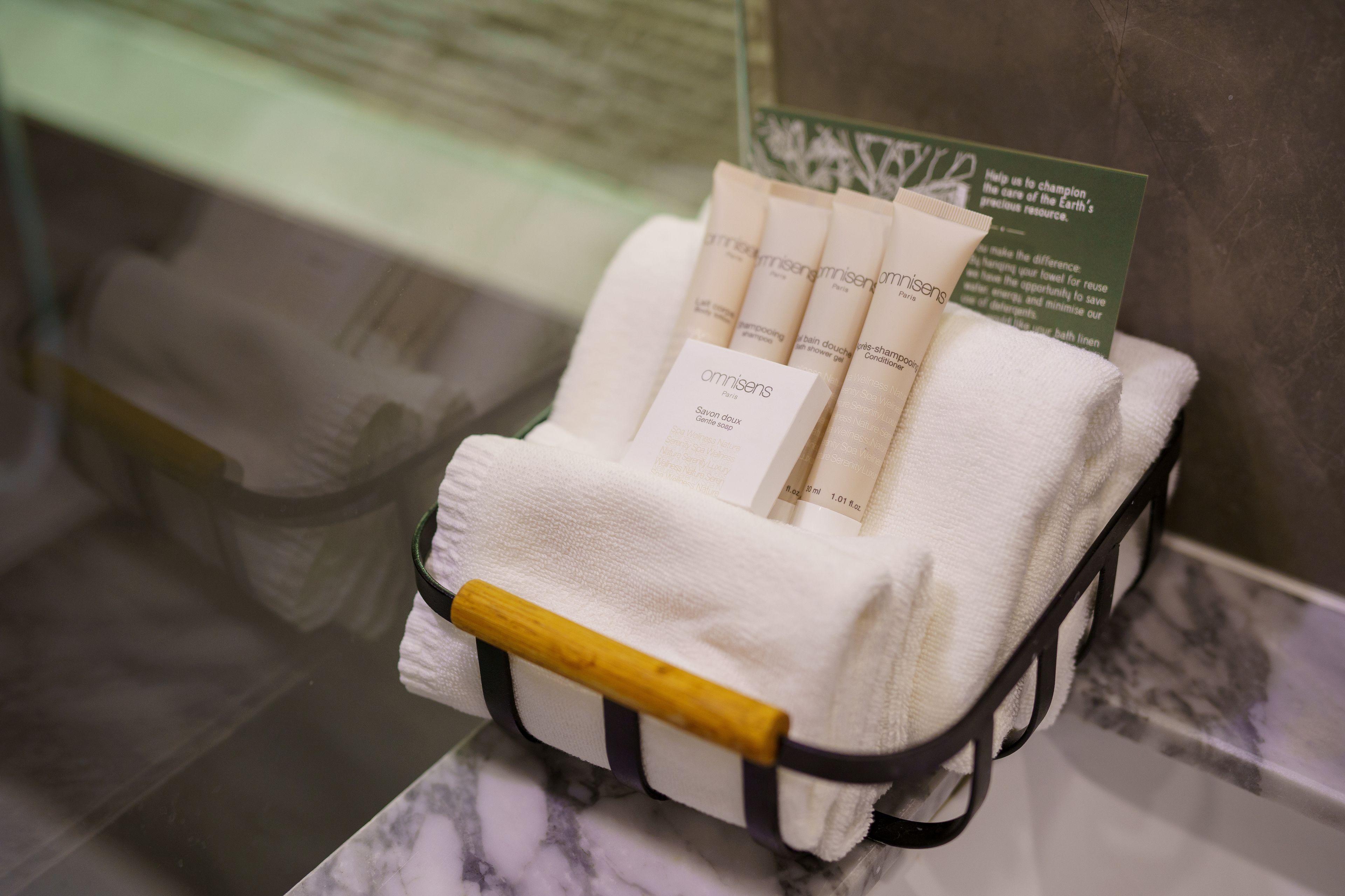 A cart with toiletries and a green informational card.