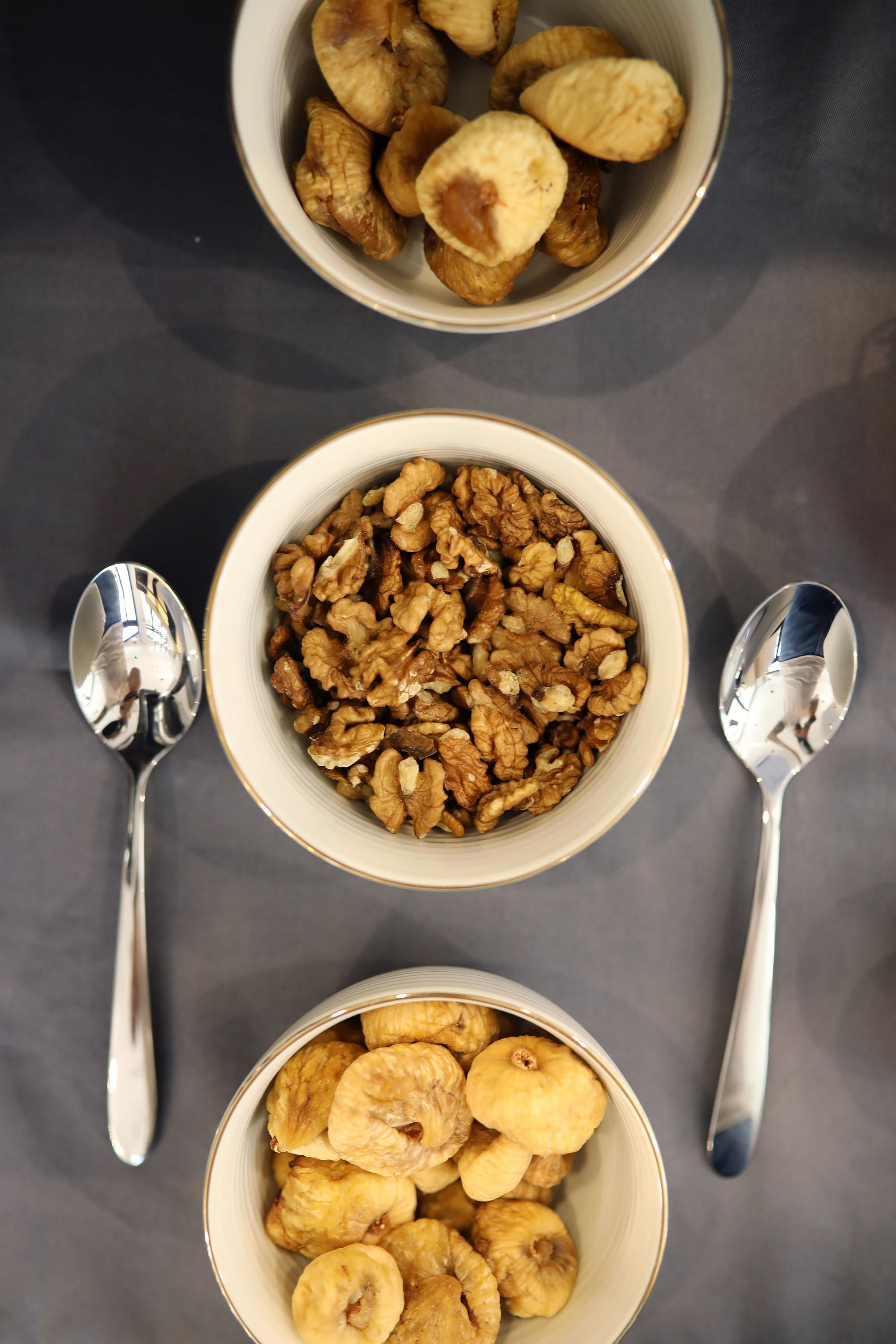 Three bowls of food items on a table.