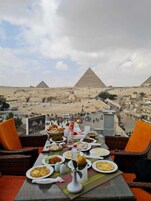 Una mesa con comida y vistas a las pirámides.