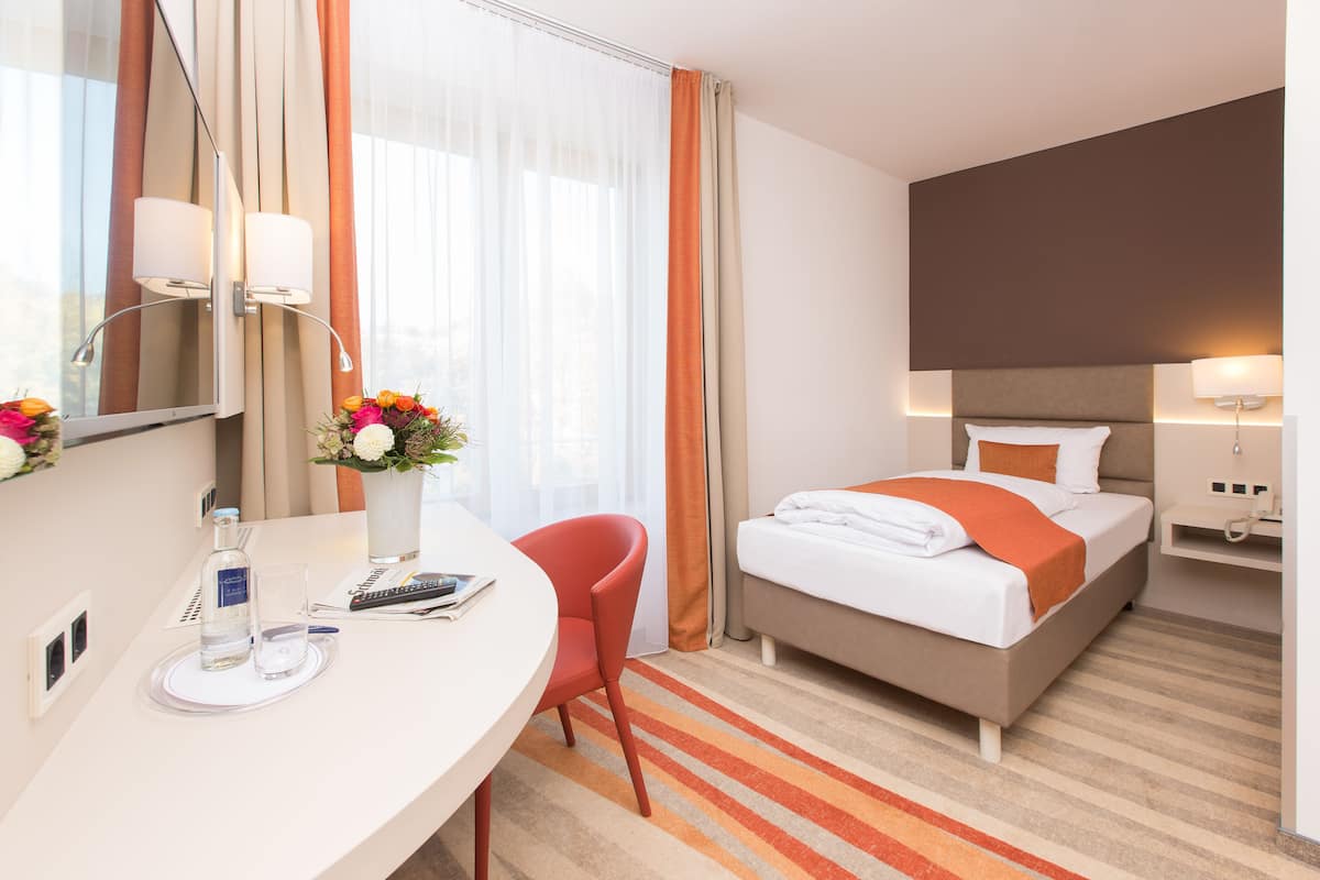 Hypo-allergenic bedding, desk, laptop workspace, blackout drapes