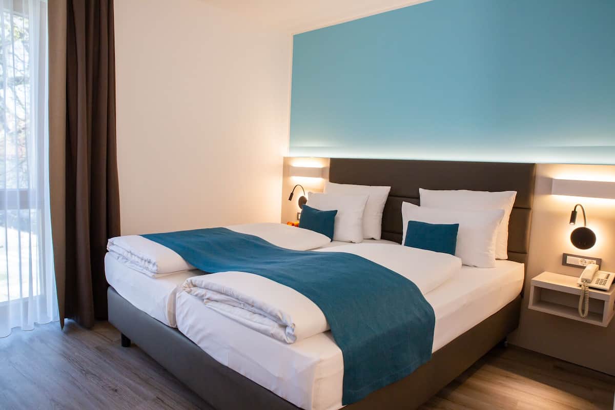Deluxe Room | Hypo-allergenic bedding, desk, laptop workspace, blackout drapes