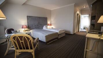 Relax in a stylish room with a large bed, flat-screen TV, and comfortable workspace.