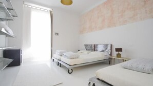 A modern hotel room with a bed, bedside table, and a large window. - A Casa di Penelope (Rome)