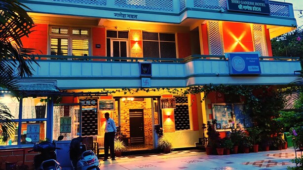 A hotel with a modern design, featuring a prominent signboard, a well-lit entrance, and a patterned pavement. - Shri Ganesh Hotel (Abu Road)