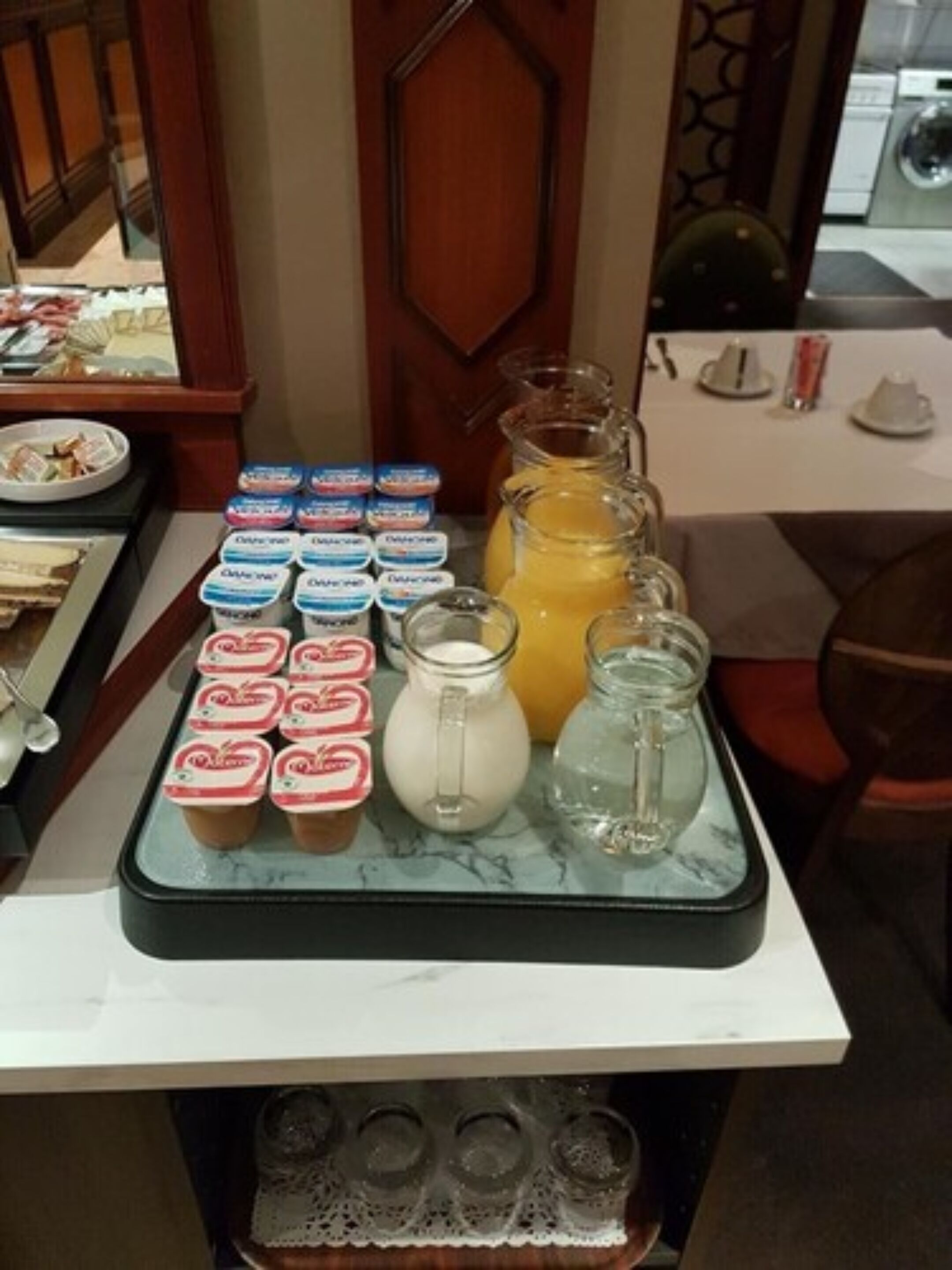 A breakfast buffet with various food items and beverages.